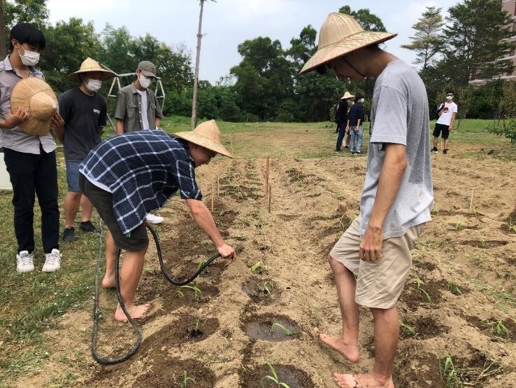 Figure 2. Leading students to plant corn crops