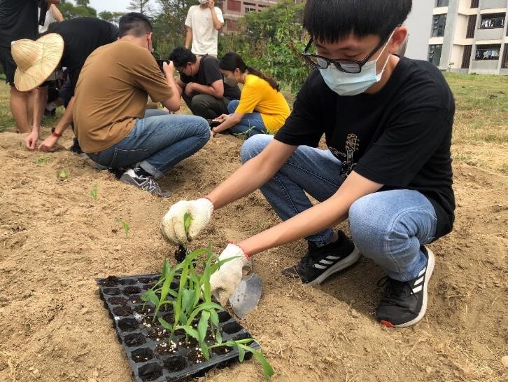 Figure 2. Leading students to plant corn crops