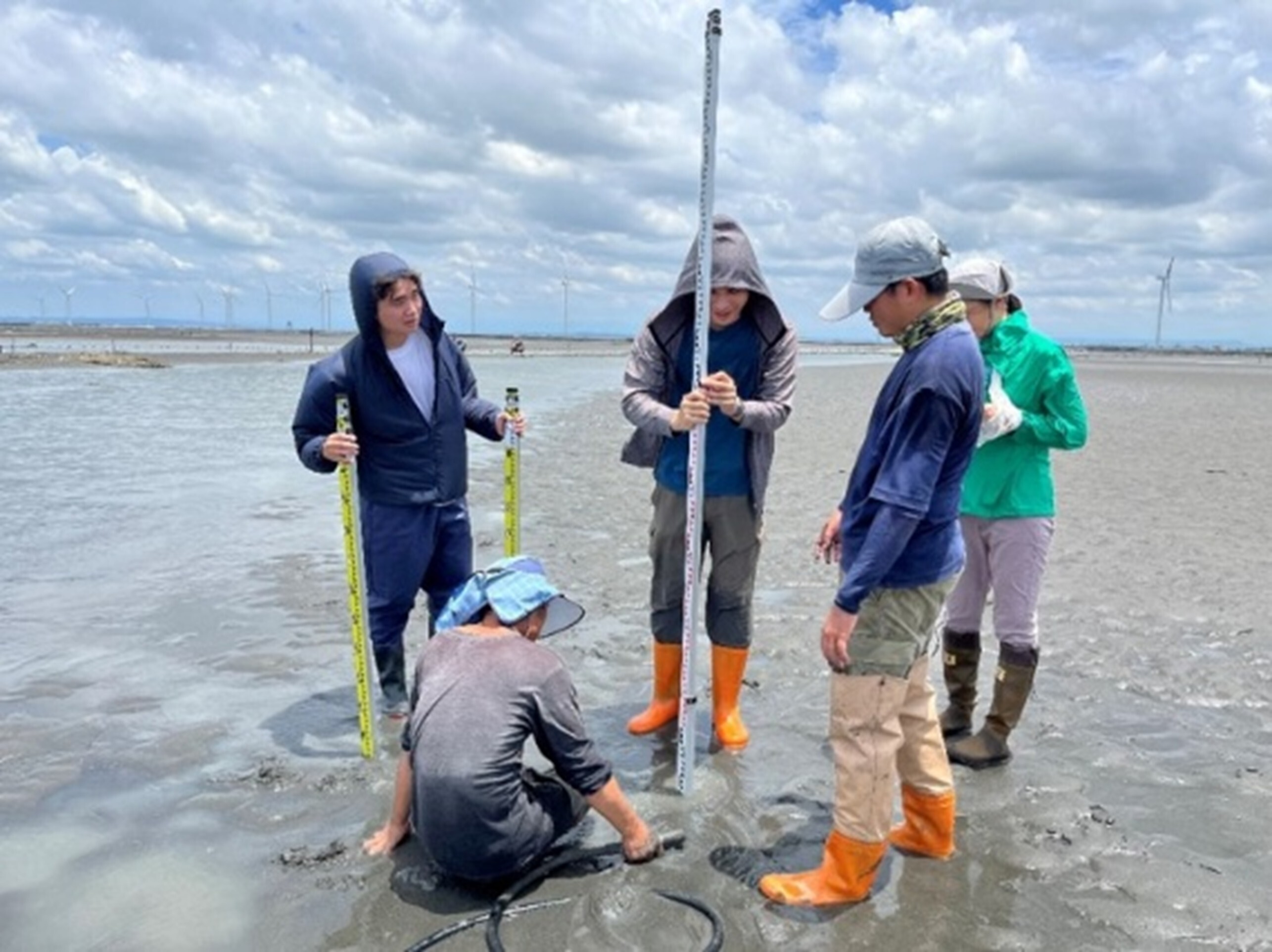Figure 3. Faculty members and students are conducting topographic monitoring at Hanbao Wetland