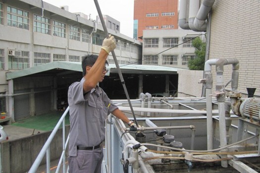 Figure 8. A worker is testing the discharged water quality treated by the sewage treatment plant on Jinde Campus