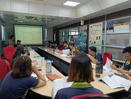 Figure 15. Host Discussing Category 4 Greenhouse Gas Inventory Plan with Greenhouse Gas Committee