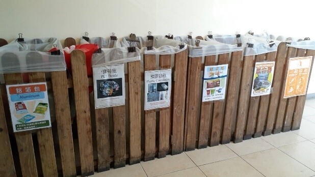 Garbage sorting and recycling buckets in NCUE (paper containers, plastic, glass, iron and aluminum cans, beverage packs, paper, PET bottles, and compost). 